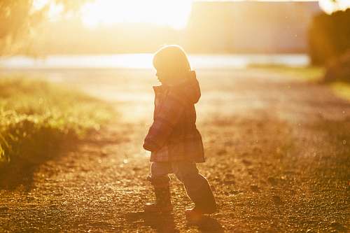 light girl walking on ground towards grass lynden